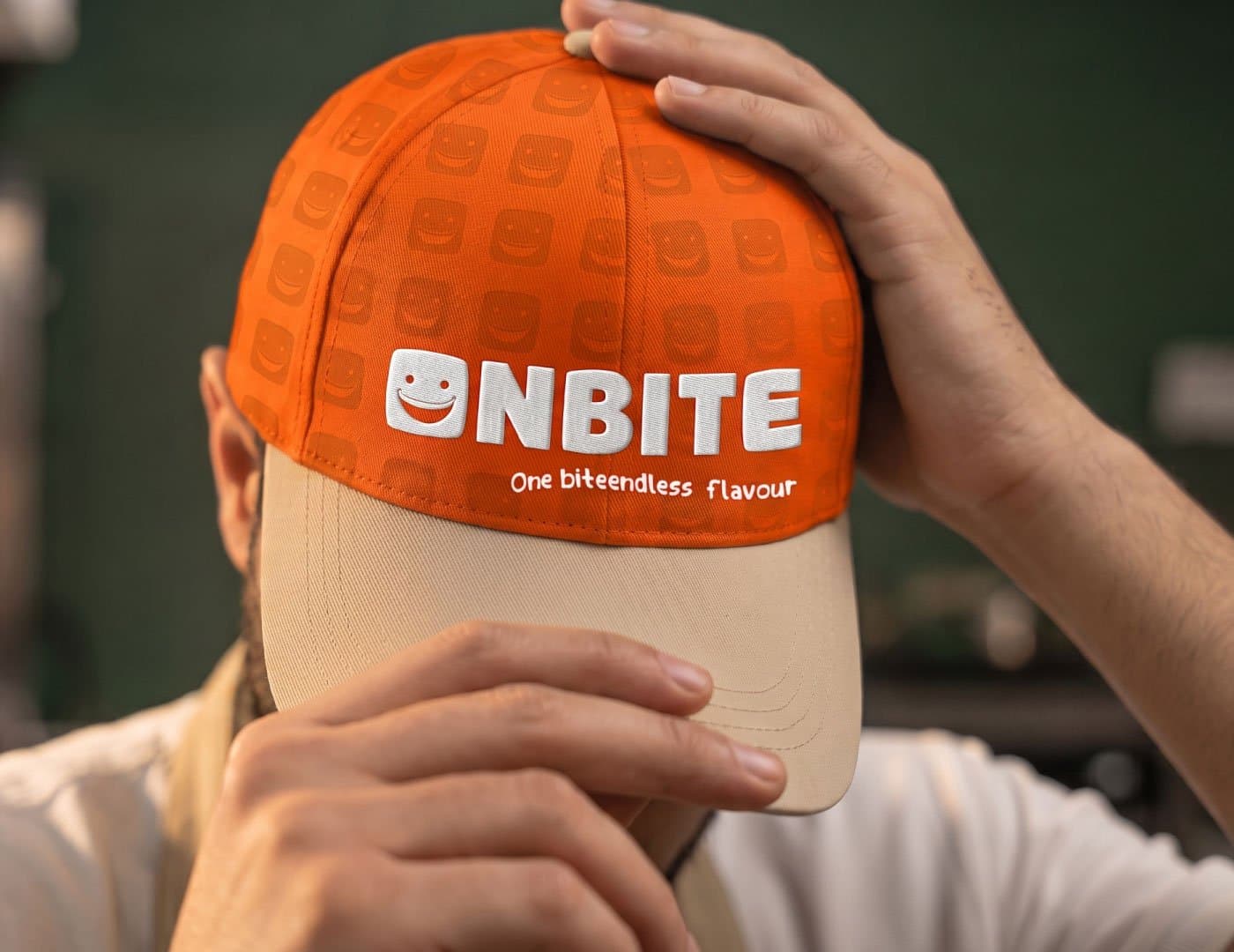 ONBITE branded menu placed on an orange restaurant chair featuring the brand pattern and Arabic menu design