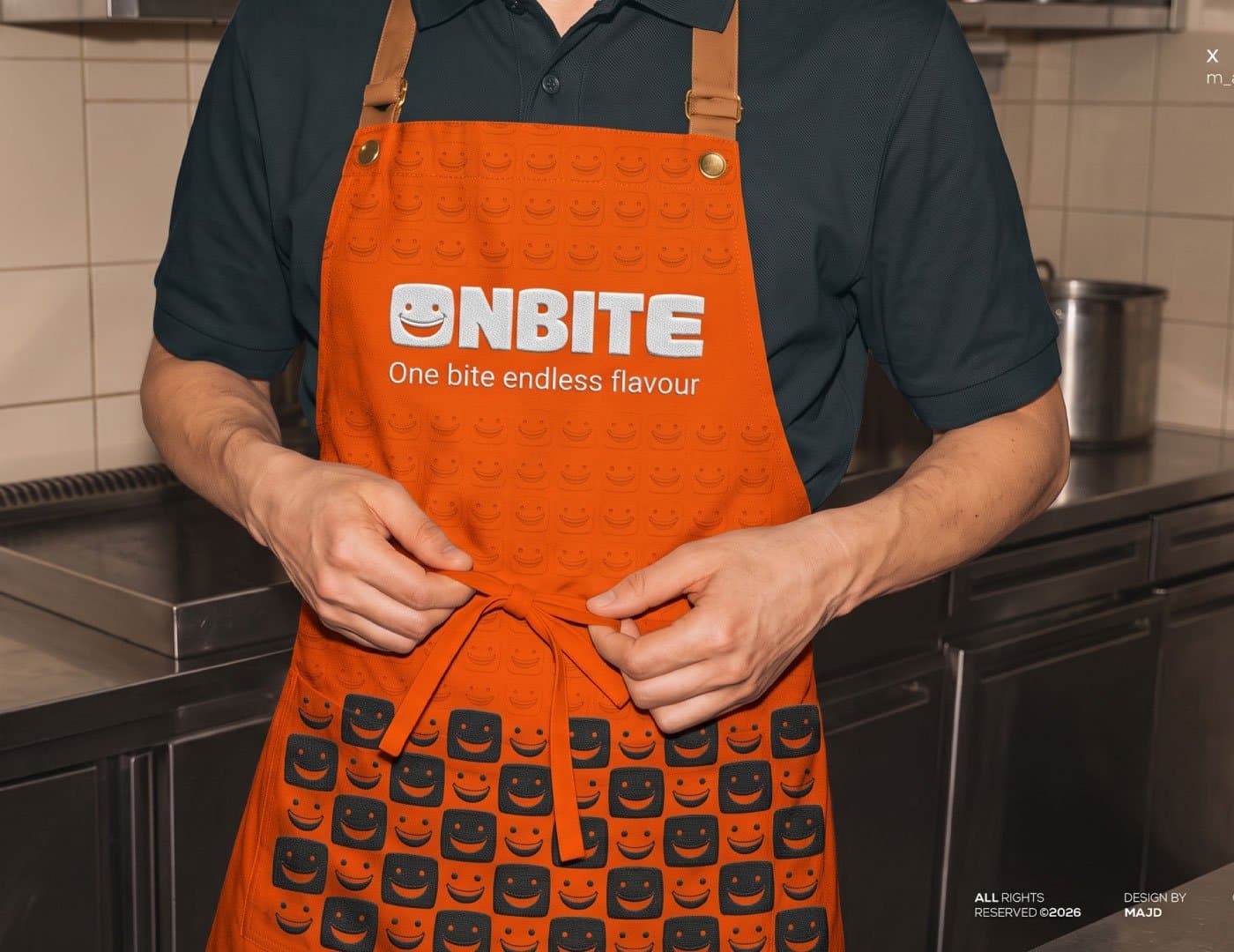 ONBITE restaurant staff apron featuring the orange brand identity, smile pattern, logo, and tagline