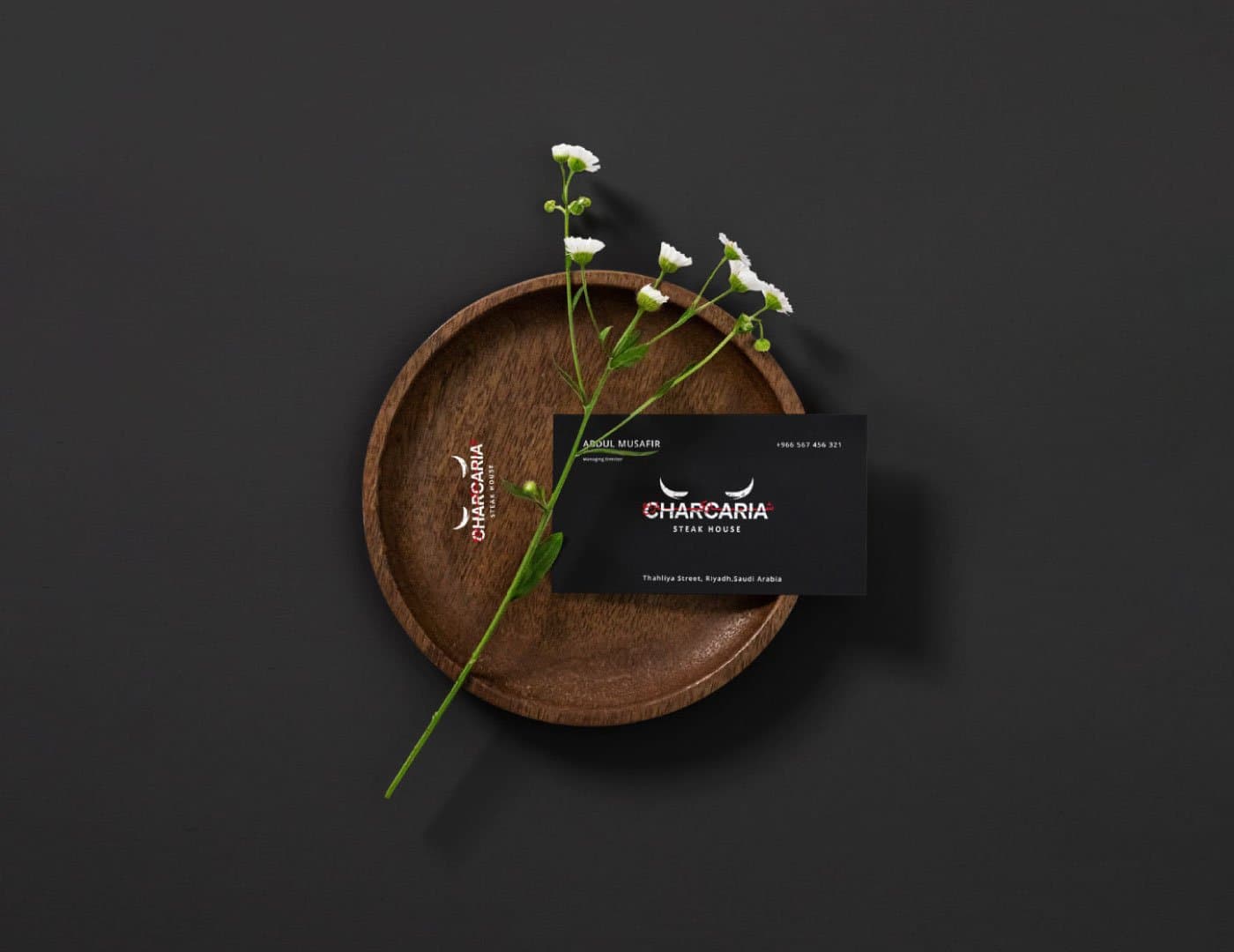Restaurant business card mockup featuring a premium dark design with metallic gold and white branding elements.